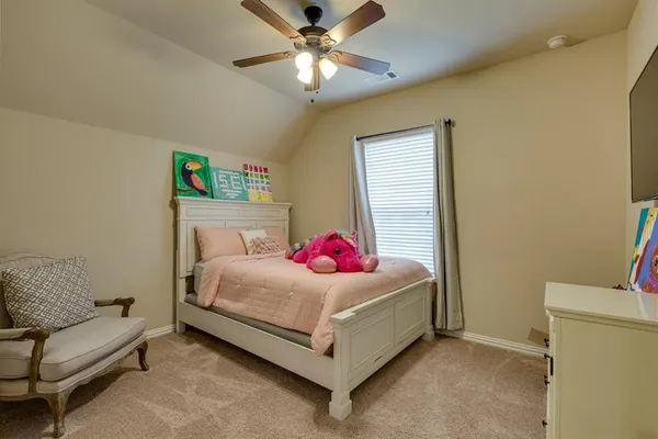 a living room with a couch and a ceiling fan