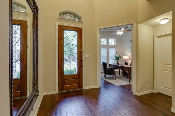 a view of a hallway view with wooden floor and furniture