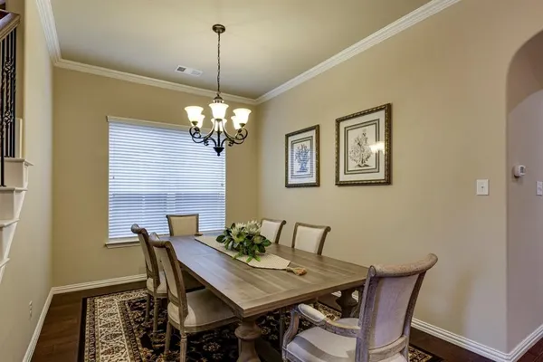 a view of a dining room with furniture and chandelier