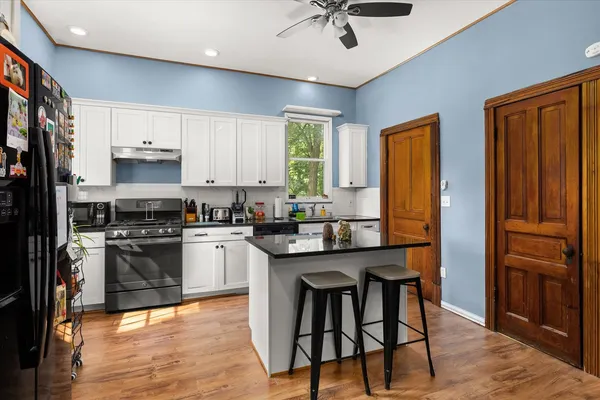 a kitchen with stainless steel appliances granite countertop a stove and a refrigerator