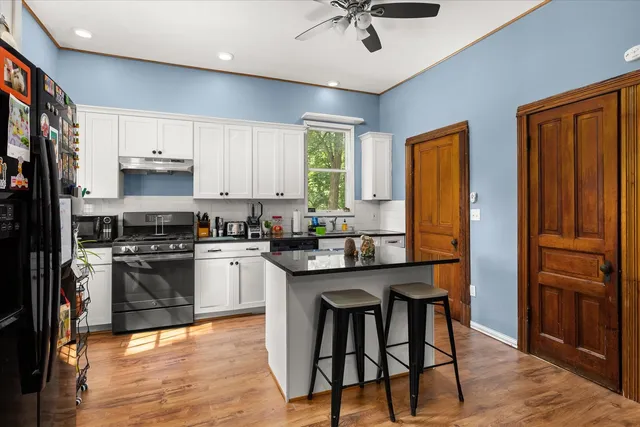 a kitchen with stainless steel appliances granite countertop a stove and a refrigerator