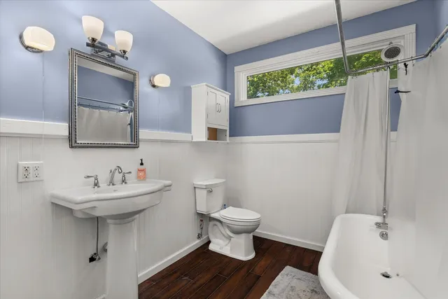 a bathroom with a sink toilet and a mirror