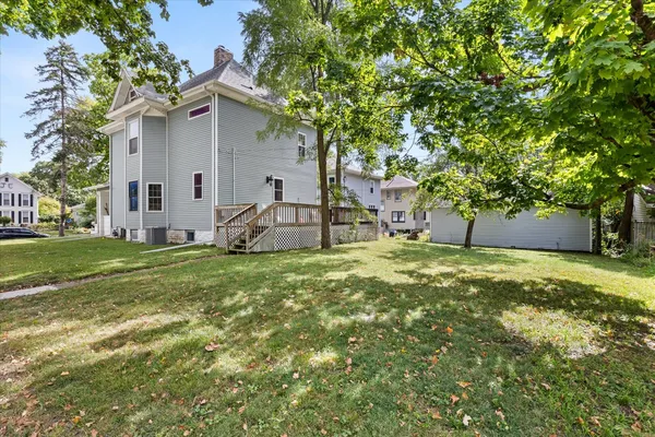 a view of a yard with large trees