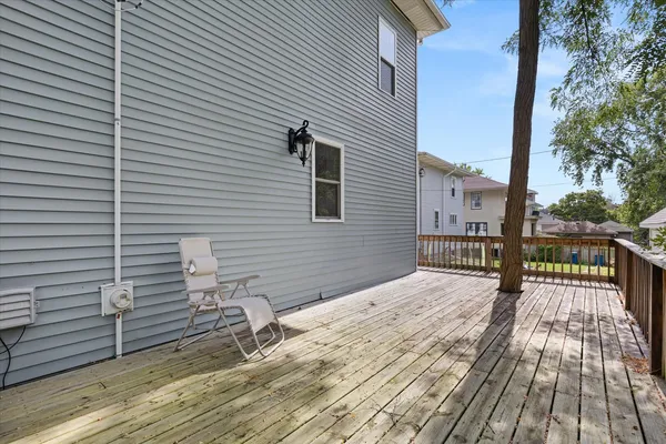 a view of balcony with wooden floor and fence