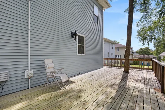 a view of balcony with wooden floor and fence