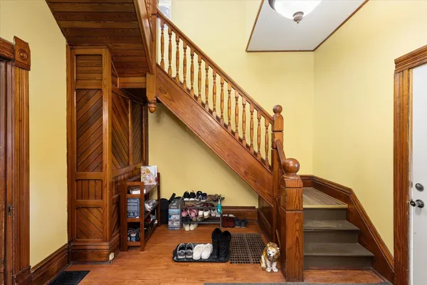 a view of entryway and hall with wooden floor