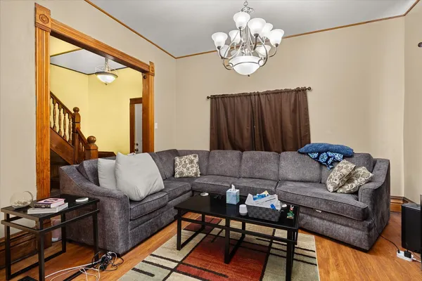 a living room with furniture a chandelier and a window