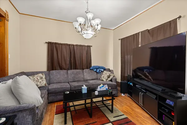 a living room with furniture a flat screen tv and a window