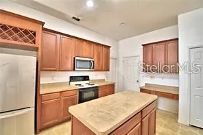 a kitchen with a refrigerator stove and sink