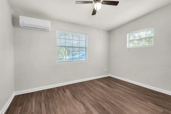 wooden floor in an empty room with a window