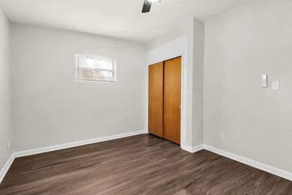 a view of an empty room with wooden floor