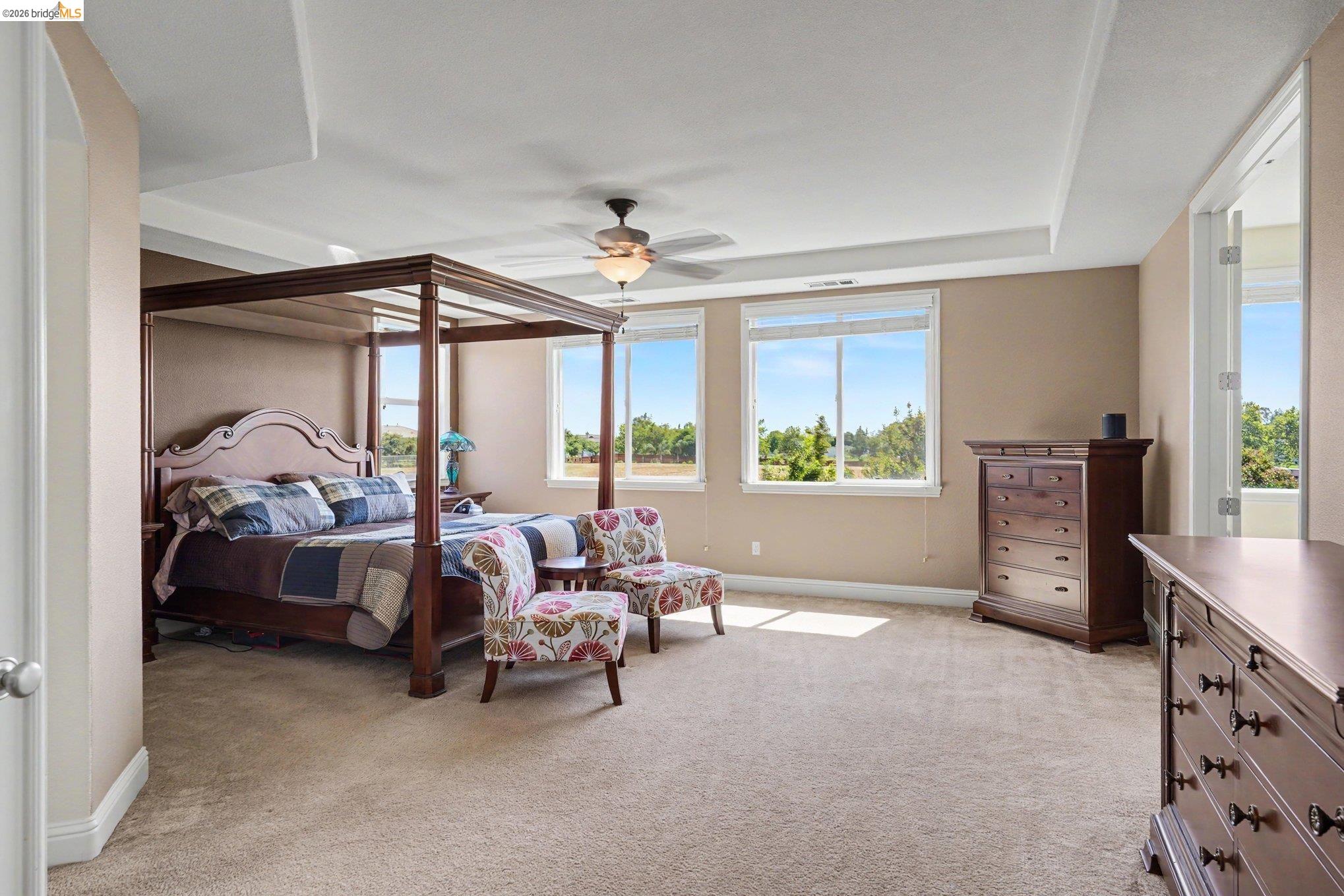 106 Little Ranch Circle Oakley, CA 94561 - Photo 21 of 34 Spacious bedroom featuring neutral carpeting, a ceiling fan, and a tray ceiling