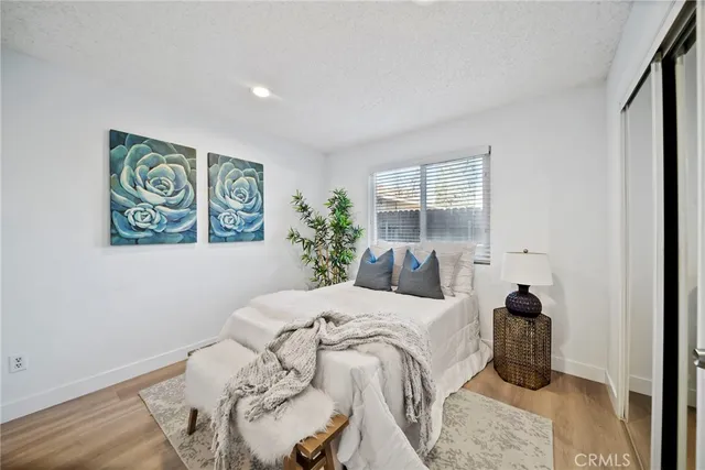 a bedroom with a bed and a painting on the wall