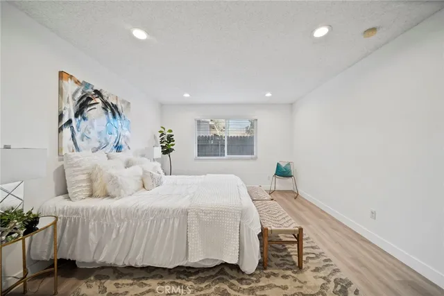 a bedroom with a large bed and a window