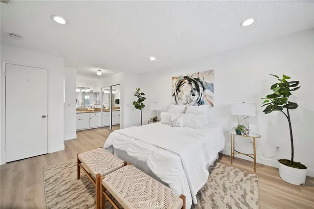 a bedroom with a bed and a potted plant