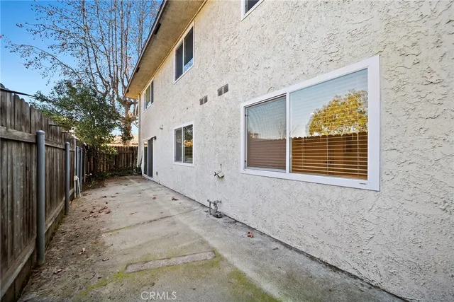 a view of a backyard with wooden fence