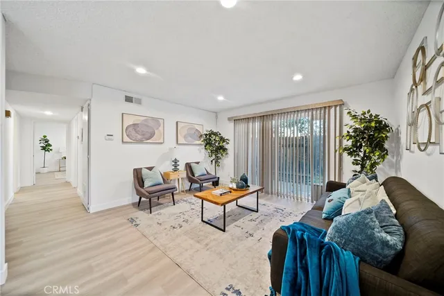 a living room with furniture and a potted plant