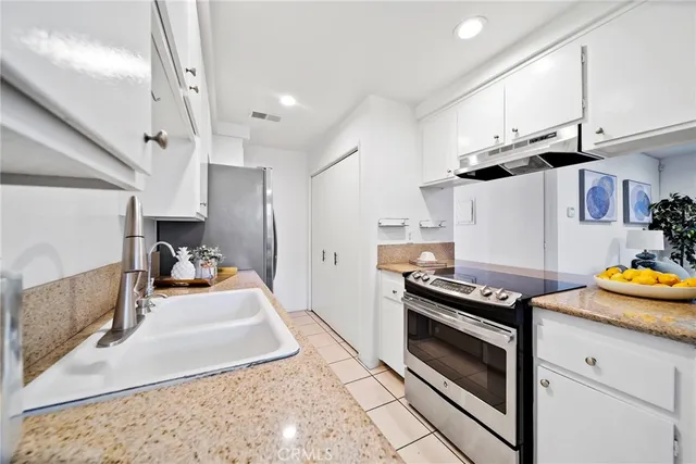 a kitchen with stainless steel appliances granite countertop a stove and a sink