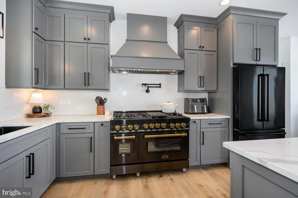 a living room with furniture a fireplace and large windows
