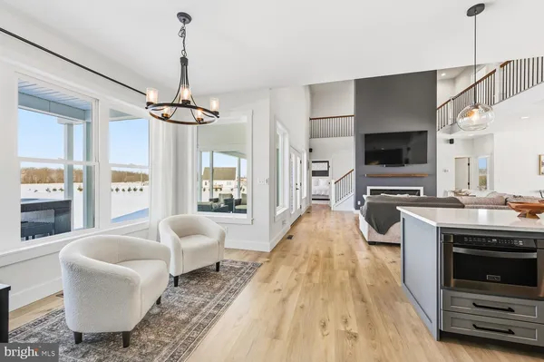 a living room with furniture and view of kitchen