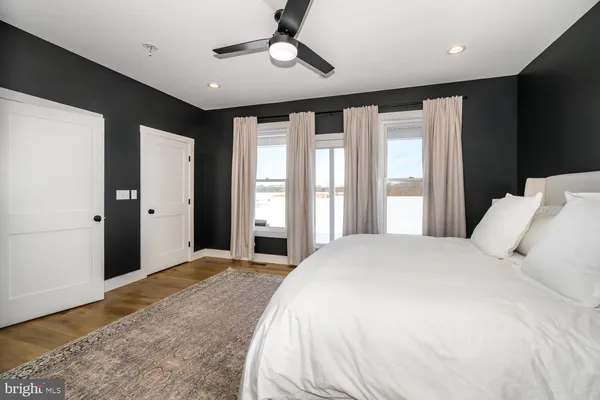 a view of a livingroom with furniture window and wooden floor