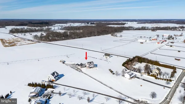 a living room with lots of white furniture and entryway