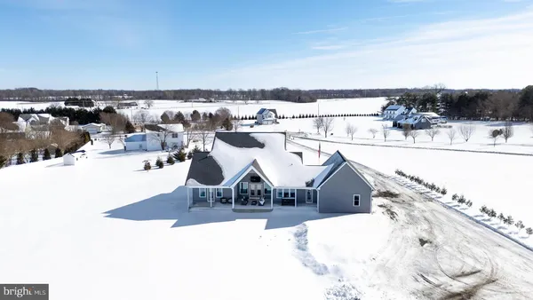 a view of a hallway with wooden floor and windows
