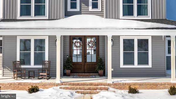 a view of a dining room with furniture wooden floor and chandelier