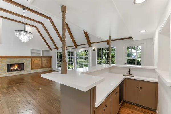 a kitchen with a sink and large windows