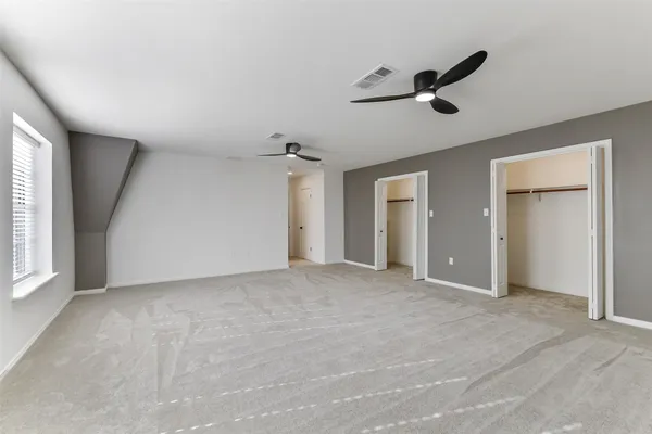 a view of a livingroom with a ceiling fan and window