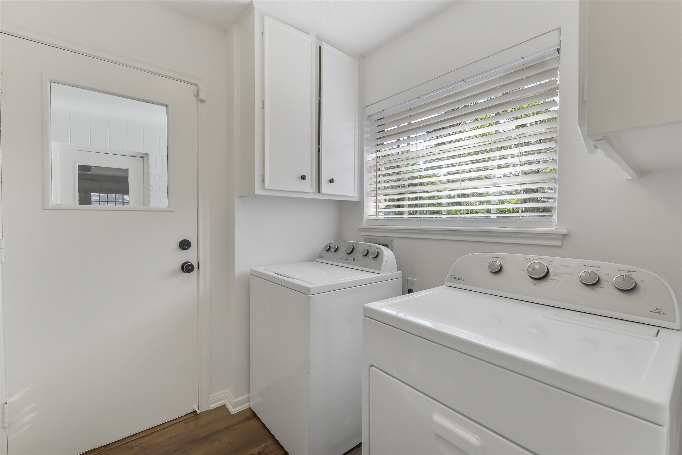 13103 Coral Ridge Court Houston, TX 77069 - Photo 31 of 43 a view of washer and dryer with bathroom in the background
