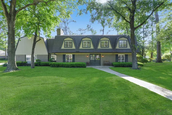 a front view of a house with a garden