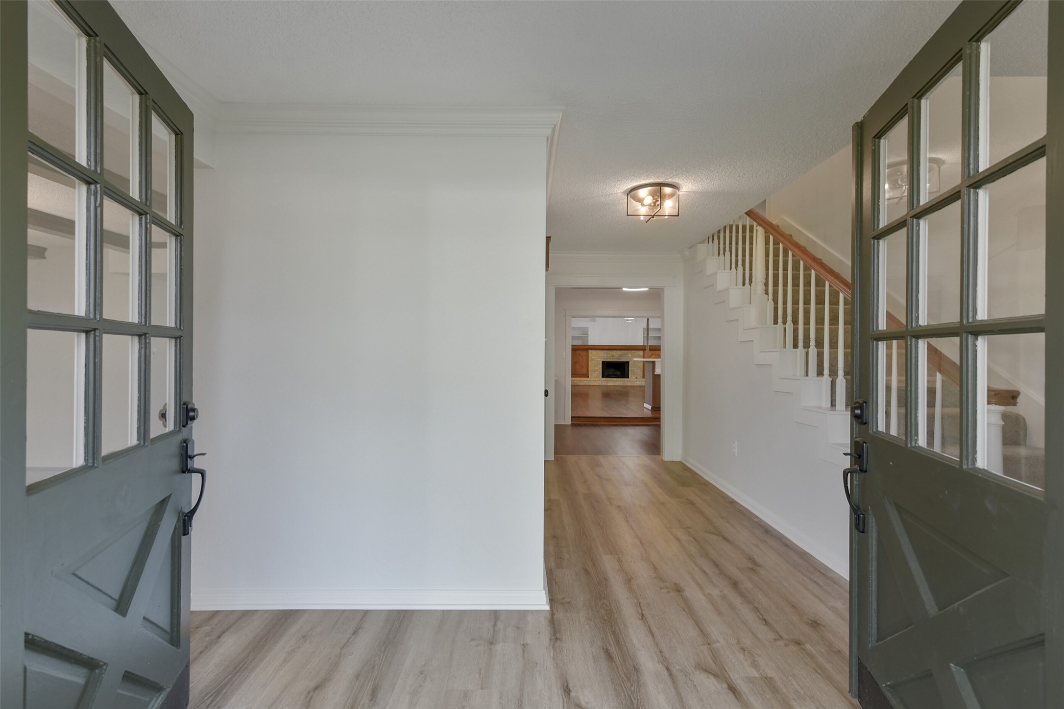 13103 Coral Ridge Court Houston, TX 77069 - Photo 4 of 43 a view of a hallway with wooden floor and staircase