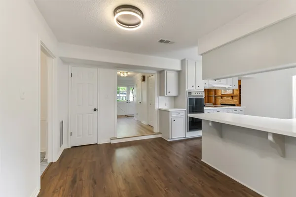 a view of a kitchen with a sink and dishwasher wooden floor