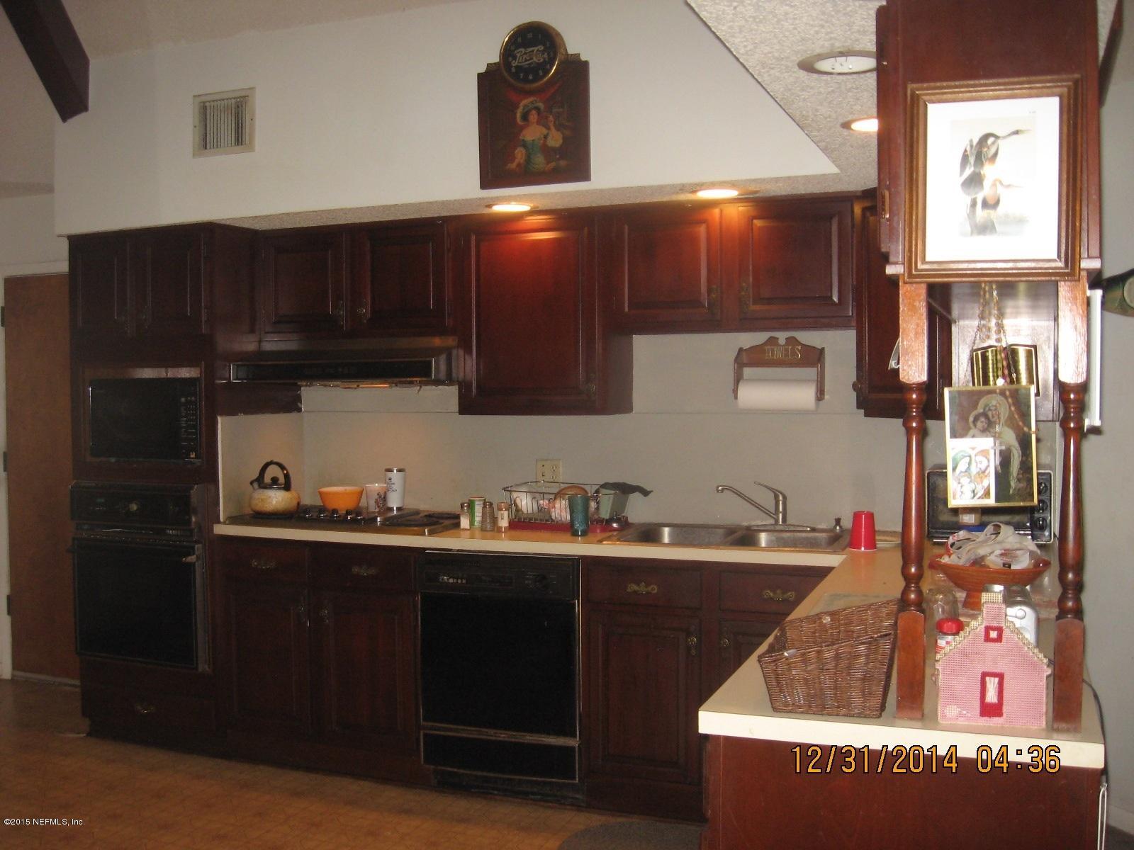 3098 I Pacetti Road St. Augustine, FL 32092 - Photo 20 of 21 a kitchen with granite countertop a sink dishwasher stove and cabinets