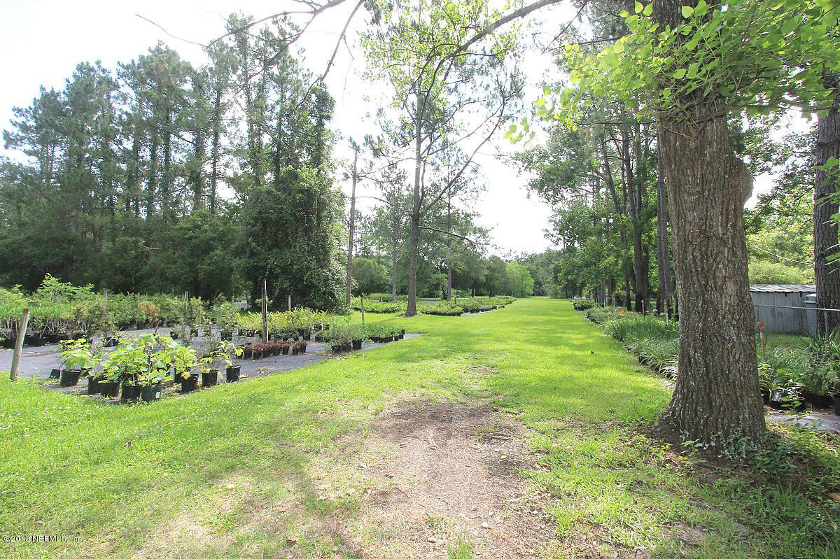 3098 I Pacetti Road St. Augustine, FL 32092 - Photo 7 of 21 a view of a backyard with table and chairs and a large tree