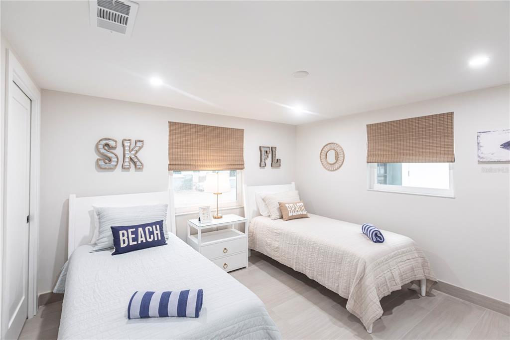 6154 Midnight Pass Road, Unit B18 Sarasota, FL 34242 - Photo 14 of 20 a bedroom with a bed and a large window