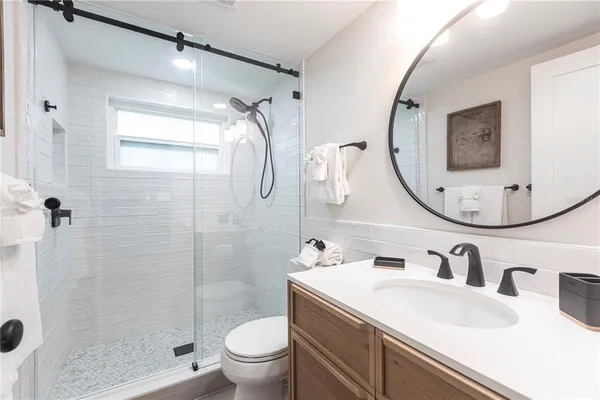 a bathroom with a sink toilet and shower