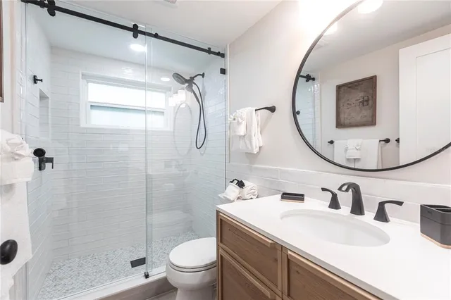 a bathroom with a sink toilet and shower