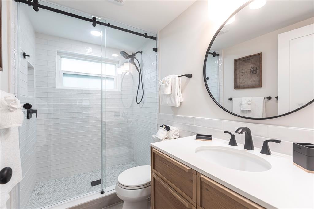 6154 Midnight Pass Road, Unit B18 Sarasota, FL 34242 - Photo 17 of 20 a bathroom with a sink toilet and shower