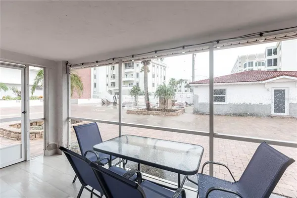 a dining room with furniture a chandelier and wooden floor
