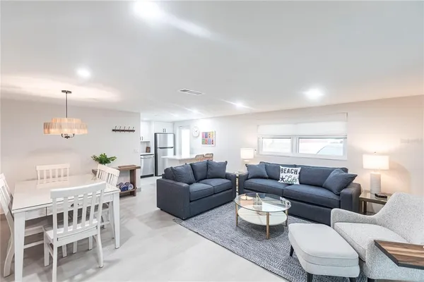 a living room with furniture a rug and a chandelier