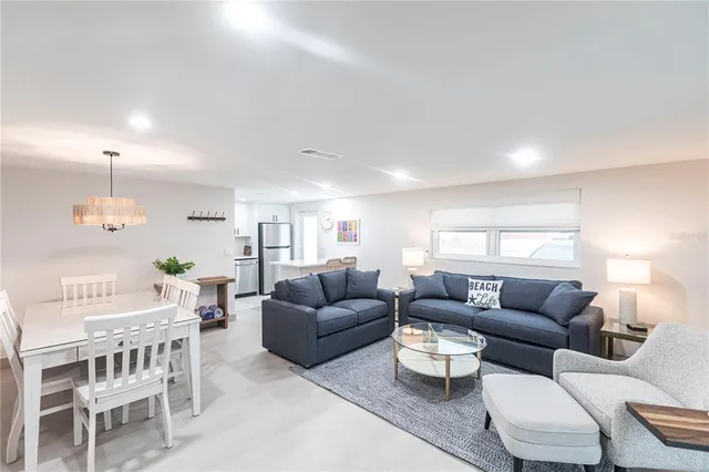 a living room with furniture a rug and a chandelier