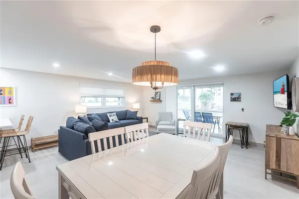 a living room with furniture a window and a chandelier