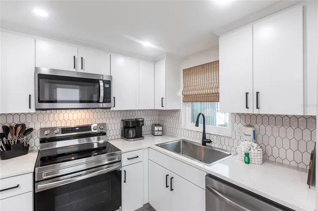 a kitchen with a sink stove and microwave