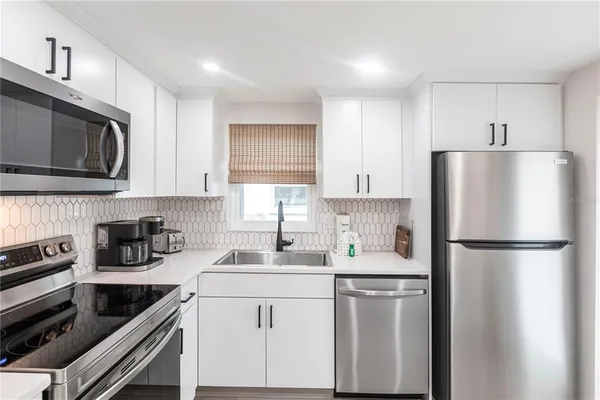 a kitchen with a refrigerator stove and microwave