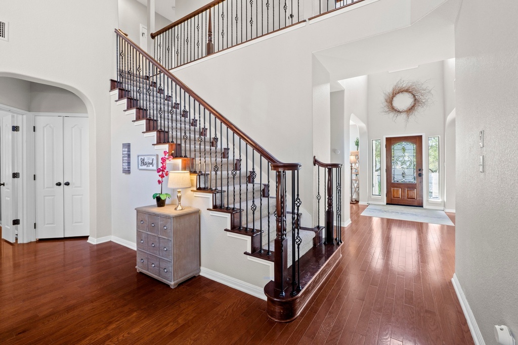 15104 Spillman Ranch Loop Austin, TX 78738 - Photo 11 of 31 a view of entryway with wooden floor and stairs