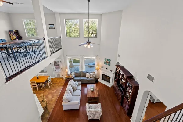 a view of a livingroom with furniture hardwood floor and windows