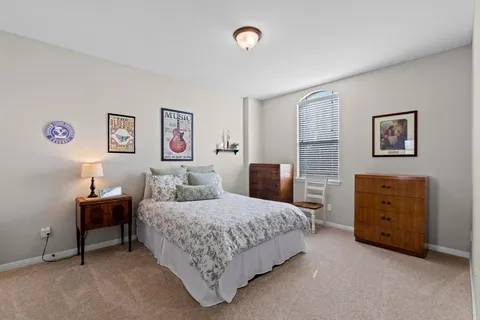 a bedroom with a bed and a desk