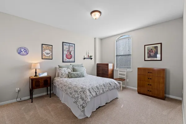 a bedroom with a bed and a desk